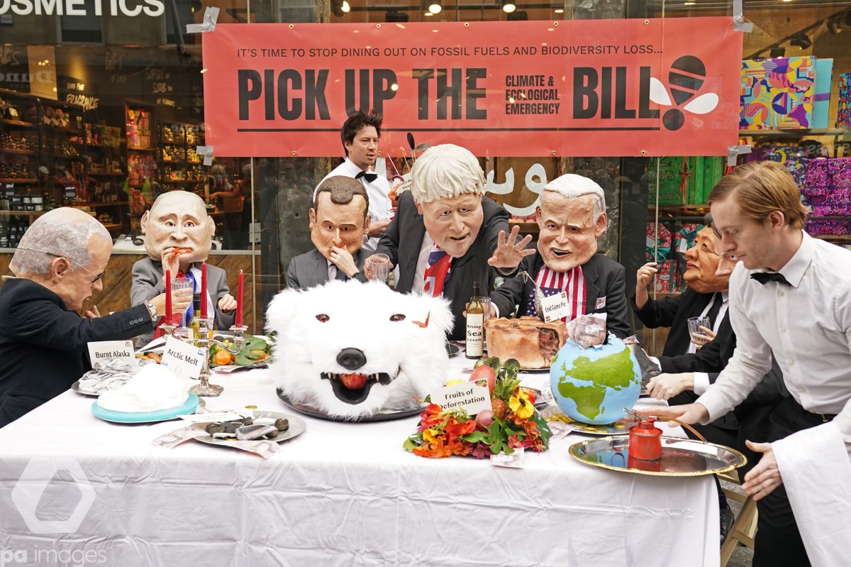 PA's tweet photo. Near the #Cop26 summit, actors dressed in masks depicting current world leaders dined at a banquet of environmental and climate degradation during a performance on Buchanan Street, Glasgow https://t.co/1hCxgNsR6V