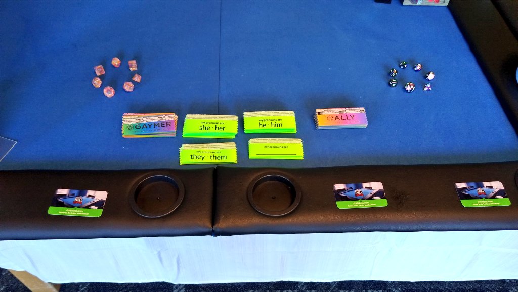newaregames's tweet photo. Setting up for @CarnageCon, we will be passing out pronoun and Gaymer ribbons from @TabletopGaymers in the Carintha lodge.  Come to booth 1 on the second floor, open at noon today! https://t.co/igLBGpZuPd