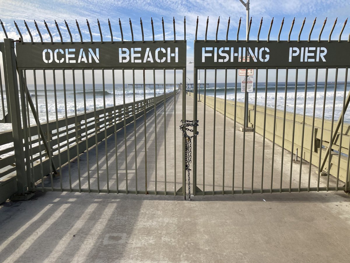 SDFD's tweet photo. High surf has caused the #OBPier to be closed as of 10:30 am. Friday. @SDLifeguards will assess the conditions and re-open when appropriate. #highsurf #cawx https://t.co/ZOlhy5FrlI