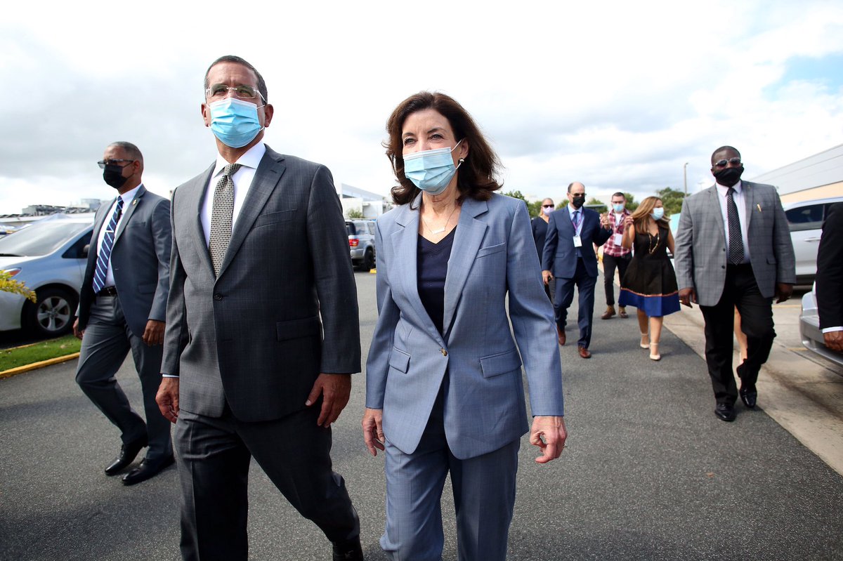 Governor Hochul and Governor Pierluisi walk to tour the SER de Puerto Rico vaccination site