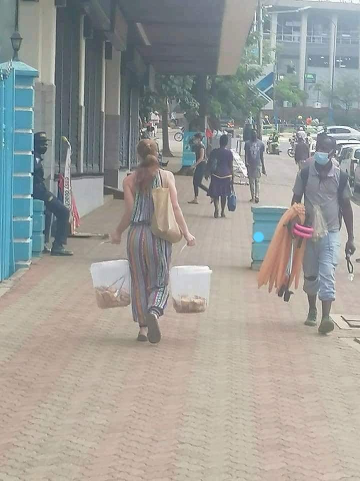 A white Lady hawking mandazi in the streets of Mombasa