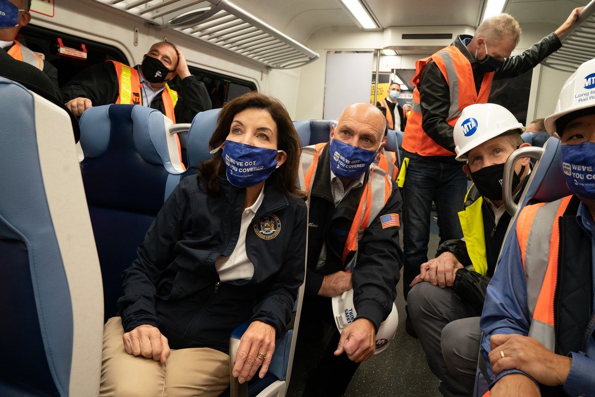 Governor Hochul sits with group of people on test run of LIRR train