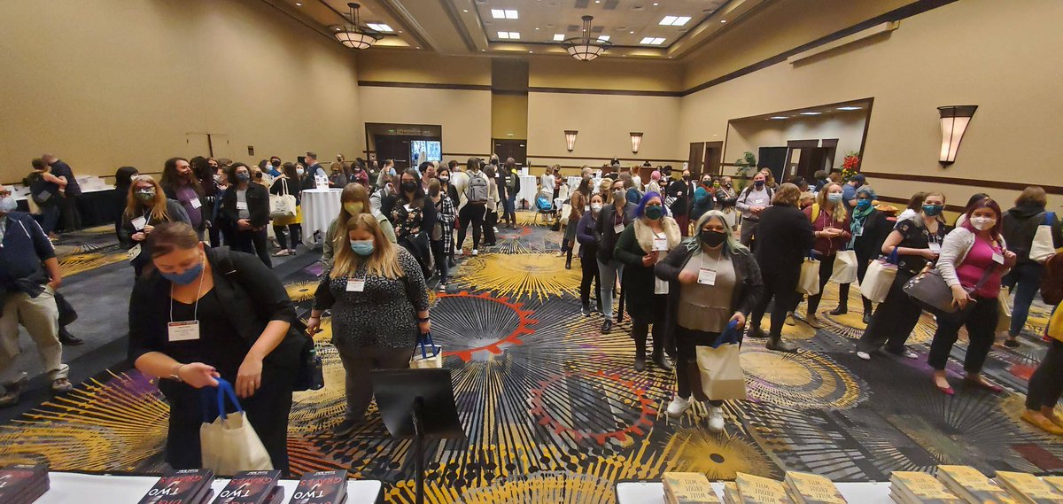 yalsa's tweet photo. They can't wait!  Wow, what a crowd for the author signing (Cory Anderson,  Gretchen McNeil,  Ellen Hopkins, Rachel Griffin, Kimberly Jones, and Gilly Segal) and reception of the YA Symposium. #YALSA21 #dayonedone #Books #librarians #YAauthors #smiles https://t.co/5IQUj6oJCg