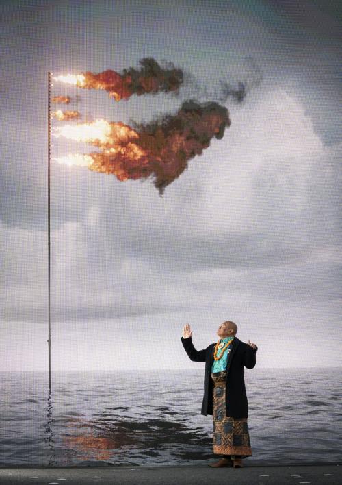 Activist Uili Lousi, from Tonga, stands alongside 'Flare (Oceania) 2021' created by @jegerrard, a real-time simulation of the seas around Tonga with a flag flare. It is presented by <a href="/hunterian/">The Hunterian</a> + <a href="/Artofchange21/">Art of Change 21</a> at the South Facade <a href="/UofGlasgow/">University of Glasgow</a> to mark Ocean Day <a href="/COP26/">COP26</a>