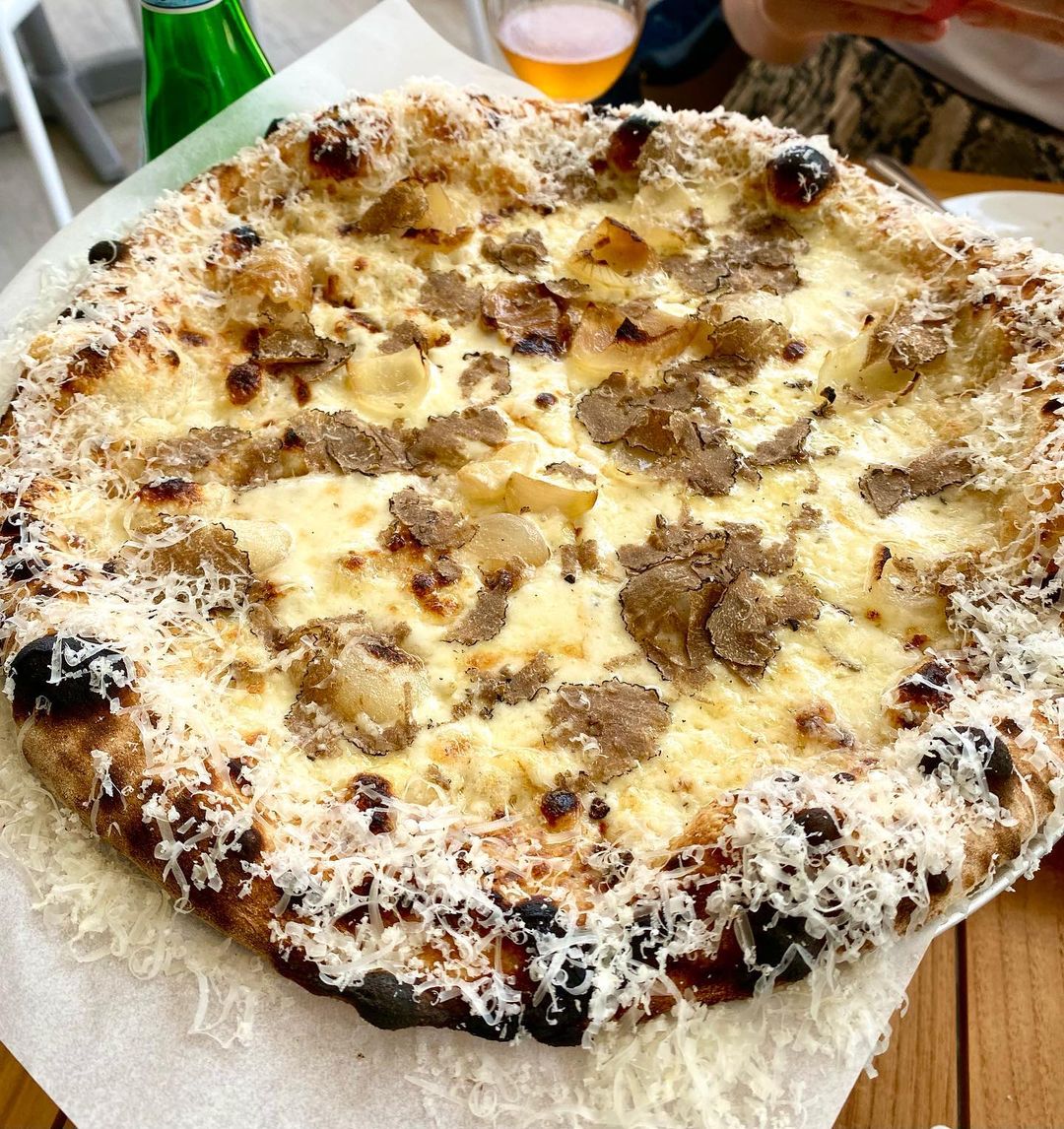 One bite is all it takes...😍 📷: Black Truffle Pizza with parmesan truffle cream, fontina, roasted cippolini onions, garlic herb breadcrumbs, parmesan crust, &amp; freshly shaved black truffles. #harryspizzeria (📷 @slissmia)