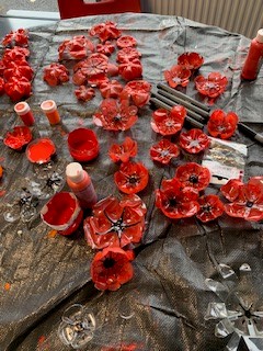 PupilSupportDGS's tweet photo. Our P12 and some wonderful student helpers have been making poppies out of plastic bottles.  These Poppies are reusable and will be going on display this week at the Dunbar monument.  Students are really enjoying making these as are the staff.  #RISE #dgs2022 https://t.co/V02wzCcGOv