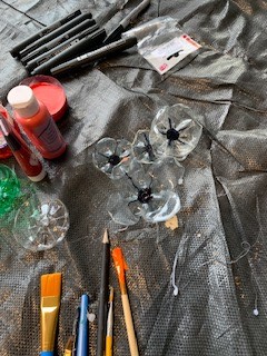 PupilSupportDGS's tweet photo. Our P12 and some wonderful student helpers have been making poppies out of plastic bottles.  These Poppies are reusable and will be going on display this week at the Dunbar monument.  Students are really enjoying making these as are the staff.  #RISE #dgs2022 https://t.co/V02wzCcGOv