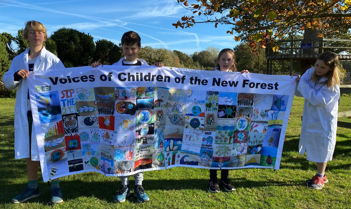 NewForestSussed's tweet photo. Four young  @walhamptonprep creators of postcards in this banner. The 700 original cards are now at #COP26. They are also scientists in a school bringing about change to reduce its carbon footprint @WalhamptonHead @mudandworms @NickyNcook @LymoTweetUp @EcoSchools @GreenHampshire https://t.co/6o9ZX7qS2A