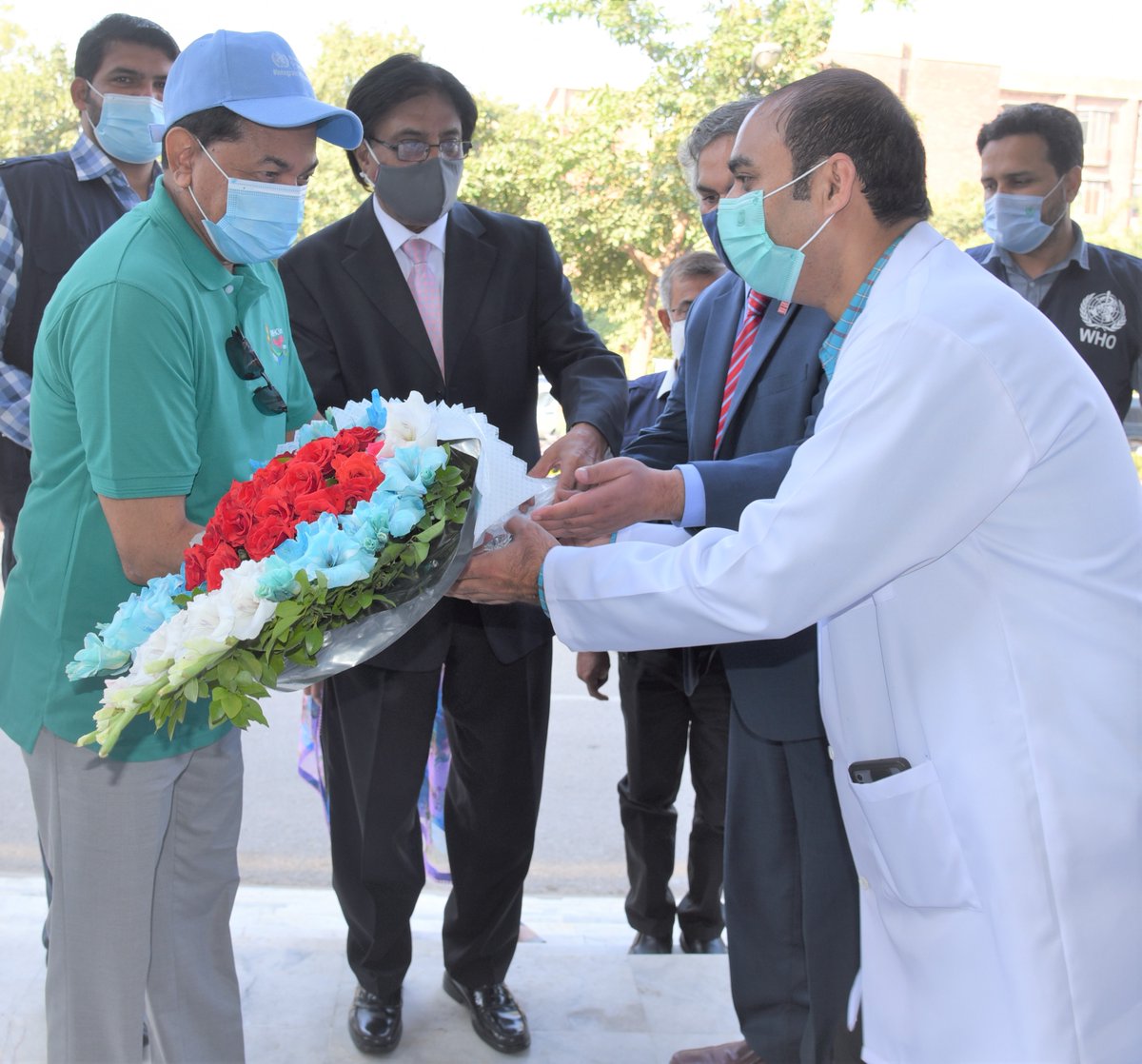 WHOPakistan's tweet photo. To encourage the people to continue following the COVID-19 precautionary measures despite the low number of cases, WR, Dr Palitha Mahipala &amp; WHO team distributed face masks &amp; IEC material among staff, patients &amp; their relatives in OPD of Holy Family Hospital. https://t.co/eaOyzjdMXM