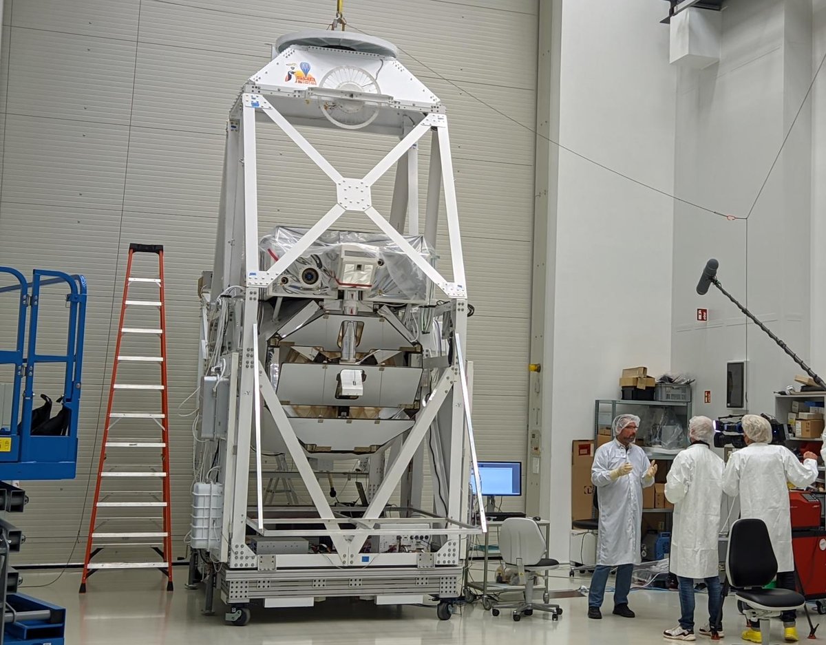 camera team filming a scientist next to the Sunrise III gondola in the balloon hall at MPS