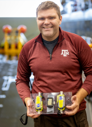 man in red shirt displays rescue beacon technology