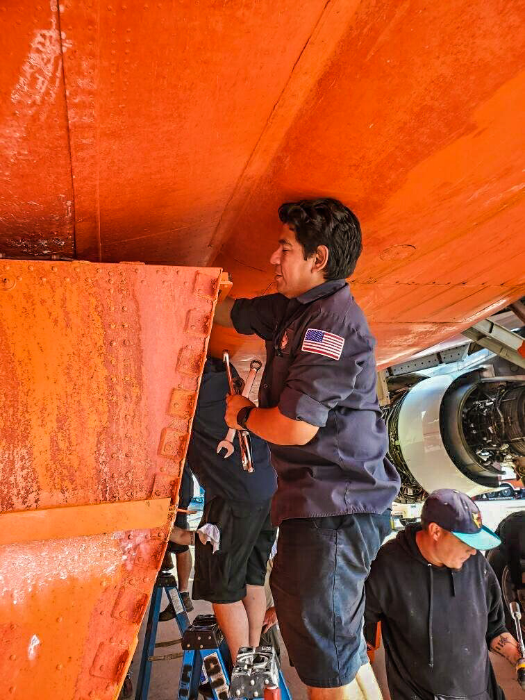Ten_Tanker's tweet photo. The #MaintenanceCrew pulls down the retardant tanks at the end of each season for preventative #maintenance and required inspection. Each tank is large enough to hold 9,400 gallons of retardant, so this is no easy task! Working hard to ensure #Ten_Tanker is always #ReadyToServe. https://t.co/cZrzDDOQZN