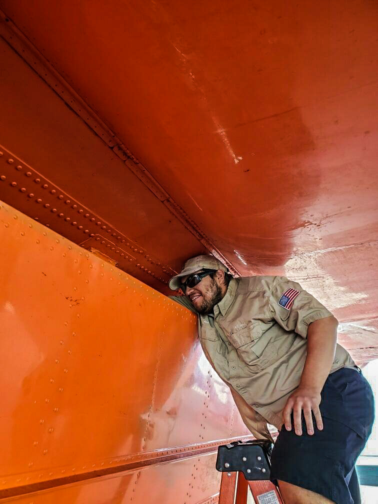 Ten_Tanker's tweet photo. The #MaintenanceCrew pulls down the retardant tanks at the end of each season for preventative #maintenance and required inspection. Each tank is large enough to hold 9,400 gallons of retardant, so this is no easy task! Working hard to ensure #Ten_Tanker is always #ReadyToServe. https://t.co/cZrzDDOQZN