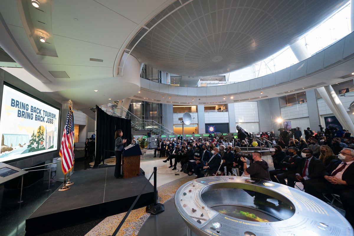 Governor Hochul stands in large room speaking to large seated crowd of people