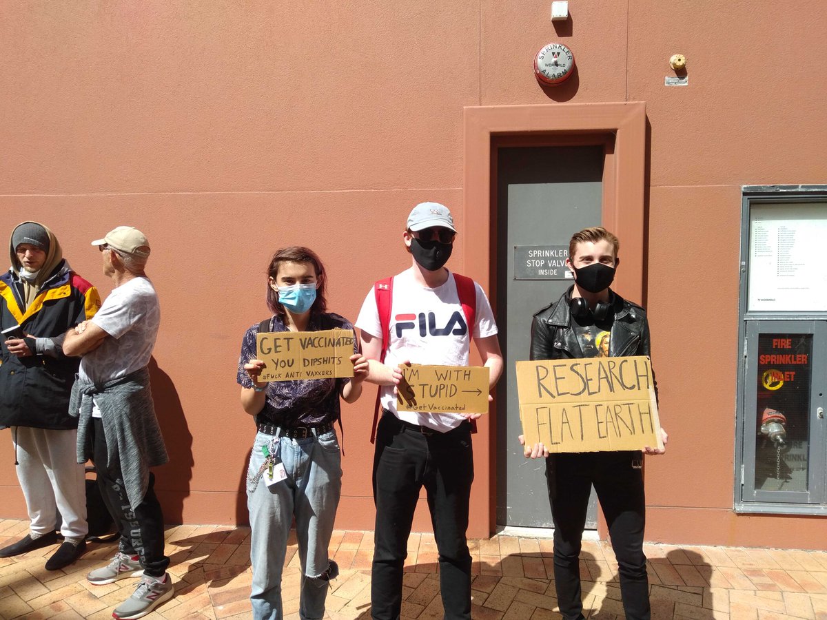 TheSpinoffTV's tweet photo. There are a few people – including @AzariaHowell – protesting the protestors with signs asking the crowd to “get vaccinated, dipshit”.

https://t.co/Ke7J9LgiRw https://t.co/mMoN6rniNp