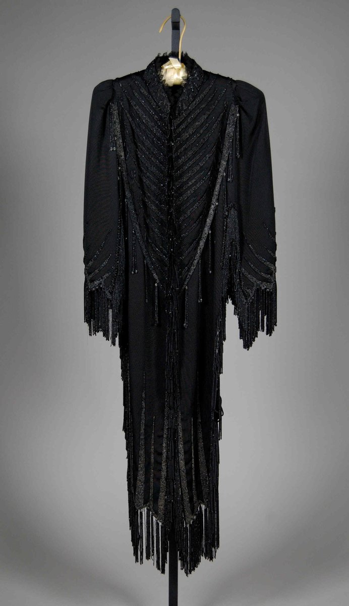 A dolman with an almost military design with the beading. From the Met Museum.