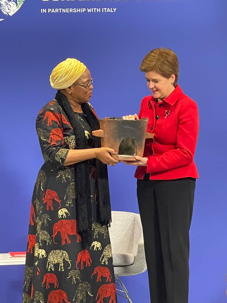 NMadise's tweet photo. Hon @nancygtembo gifting a ‘cleaner’ stove made in Malawi to Scottish 1st Secretary Nicola Sturgeon. In her comments, Nicola Sturgeon said we mustn’t talk of donations or aid for #climatechange to poor countries. Rather, this is funding to make reparations for the “loss &amp; damage” https://t.co/xI2xjWKkdx