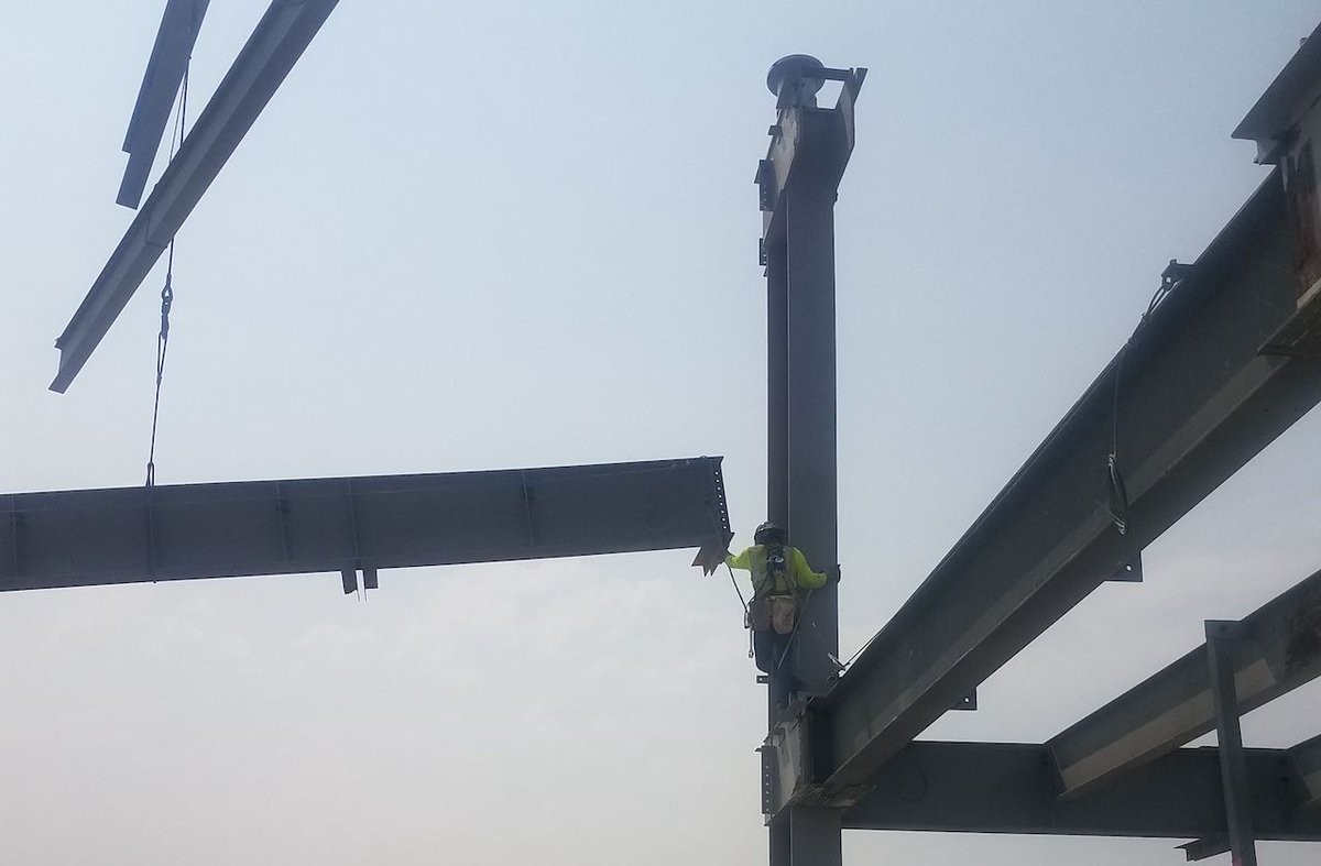 Safety in action with good fall protection practices during multiple lift rigging and connecting.