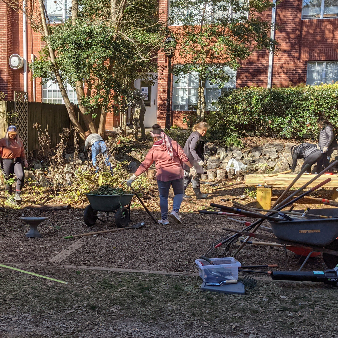 Over 50 parent volunteers helped clear overgrowth from the area outside two elementary classrooms making for new outdoor class spaces. Earlier Georgia Tech researchers removed a yellow jackets' nest.  Students helped spread woodchips donated by parents. #paideiaurbanag
