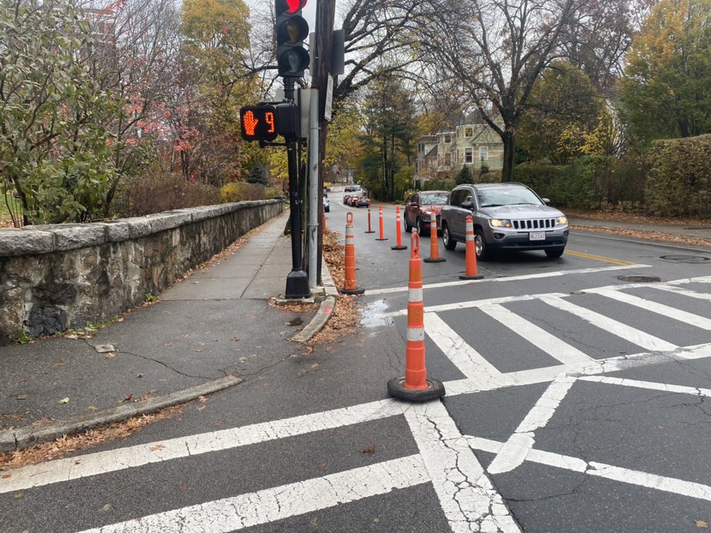 BlineTransport's tweet photo. Notice: the traffic signal at Longwood &amp; Kent has been reprogrammed to an exclusive pedestrian phase. So all 🚗🚛 stop when 🚶🏿🚶‍♂️walk. Temporary curb extensions have been created using 48inch cones. Bollards bolted into the pavement will replace the cones once they arrive. https://t.co/4iCKNgk4e4