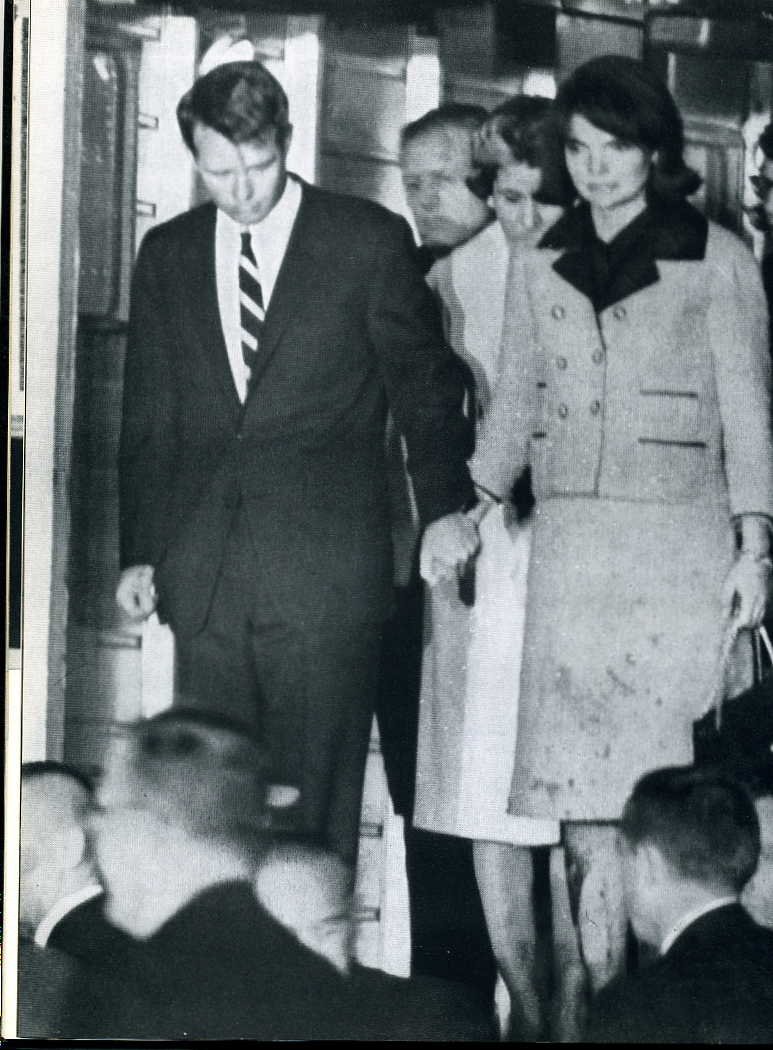 Robert Lusetich on X: One of the most poignant images of November 22,  1963: Jackie Kennedy holding her brother-in-law's hand wearing her famous pink  Chanel dress covered in her husband's blood. She