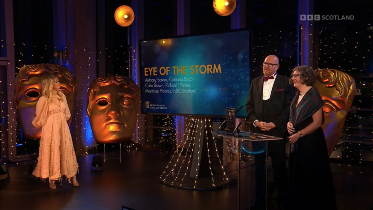 Screenshot from BBC Scotland's coverage of the British Academy Scotland Awards - Presenter Edith Bowman, Director Anthony Baxter and animator Catriona Black at the ceremony
