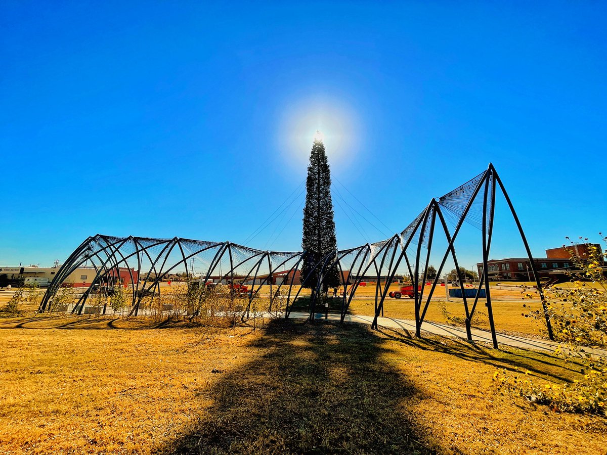 EnidBuzz's tweet photo. Enid’s Christmas tree. Drive by in the daylight to see all of the colorful ornaments. They should be done today & soon 10 smaller Christmas trees will surround the base of the large tree. Come to Enid on Friday to see it lit with fireworks in the background. #theoneenid https://t.co/jQwDEEXnqM