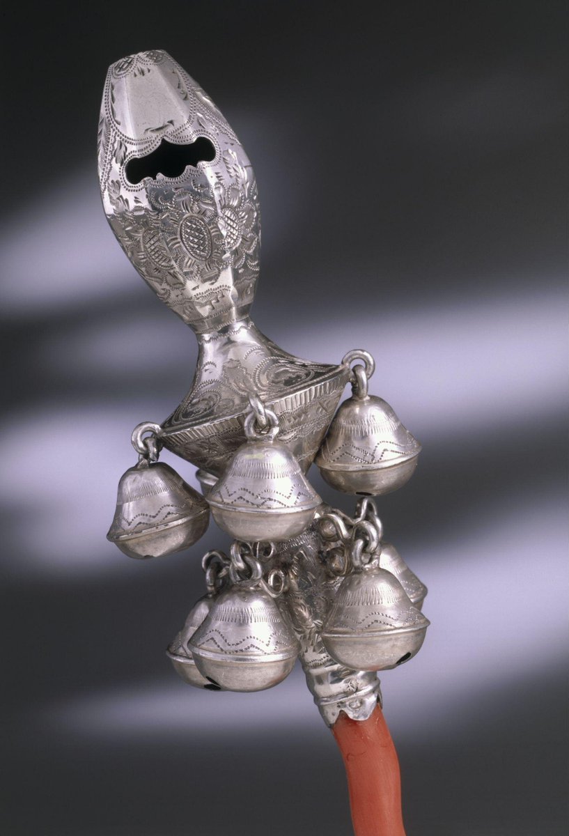 Child's rattle, a silver octagonal whistle decorated with bright-cut engraving. It has a round stem set with two rows of four bells, and ending in a piece of coral, 1823-24. Victoria &amp; Albert Museum.