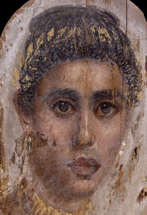 A mummy-portrait from #Roman Egypt, depicting the face of a young woman. She is shown wearing several pieces of gold jewellery, including a myrtle wreath, which were picked out in gold leaf. We don't know her name; she probably died in the early C2nd AD (📷 British Museum)