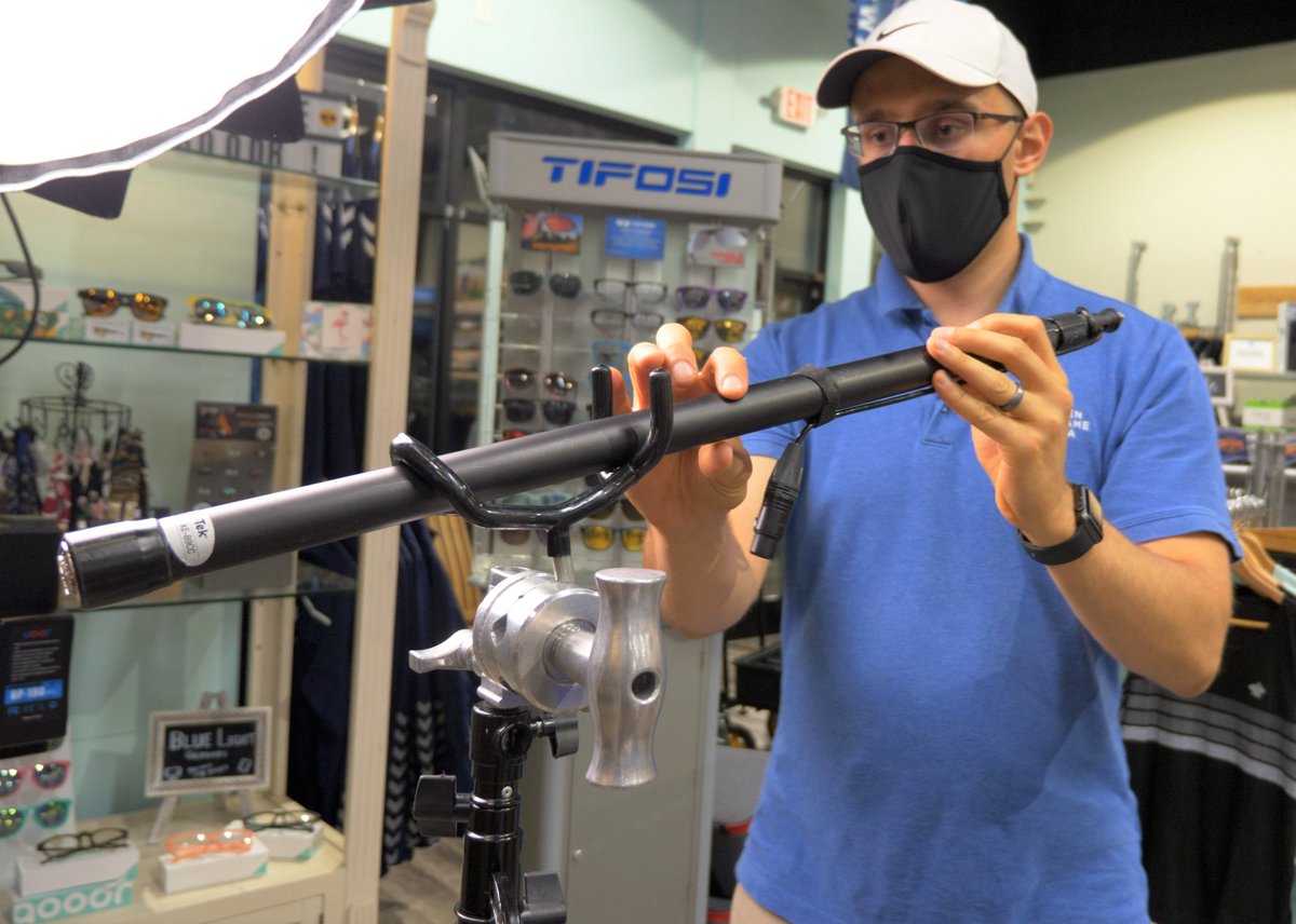 Wesley setting up the boom pole to hold the microphone for filming an interview.