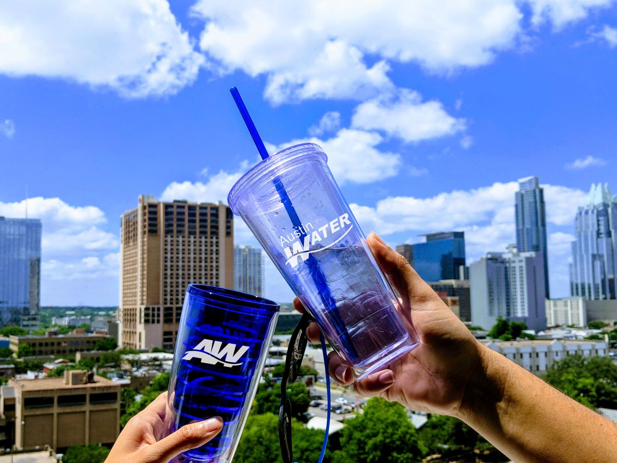 image of "cheering" water cups with Austin Water logo on them and the Austin downtown skyline in the background.