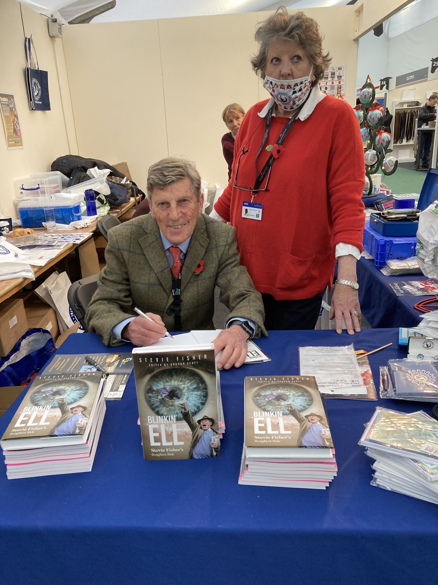 Great to be with Chicky Oaksey signing copies of Stevie Fisher’s book ‘Blinkin ‘Ell on the IJF stand at Cheltenham. Come and see us again tomorrow and get one of the most remarkable books ever written. 33,000 words, blink by blink, letter by letter with Stevie’s left eyebrow .