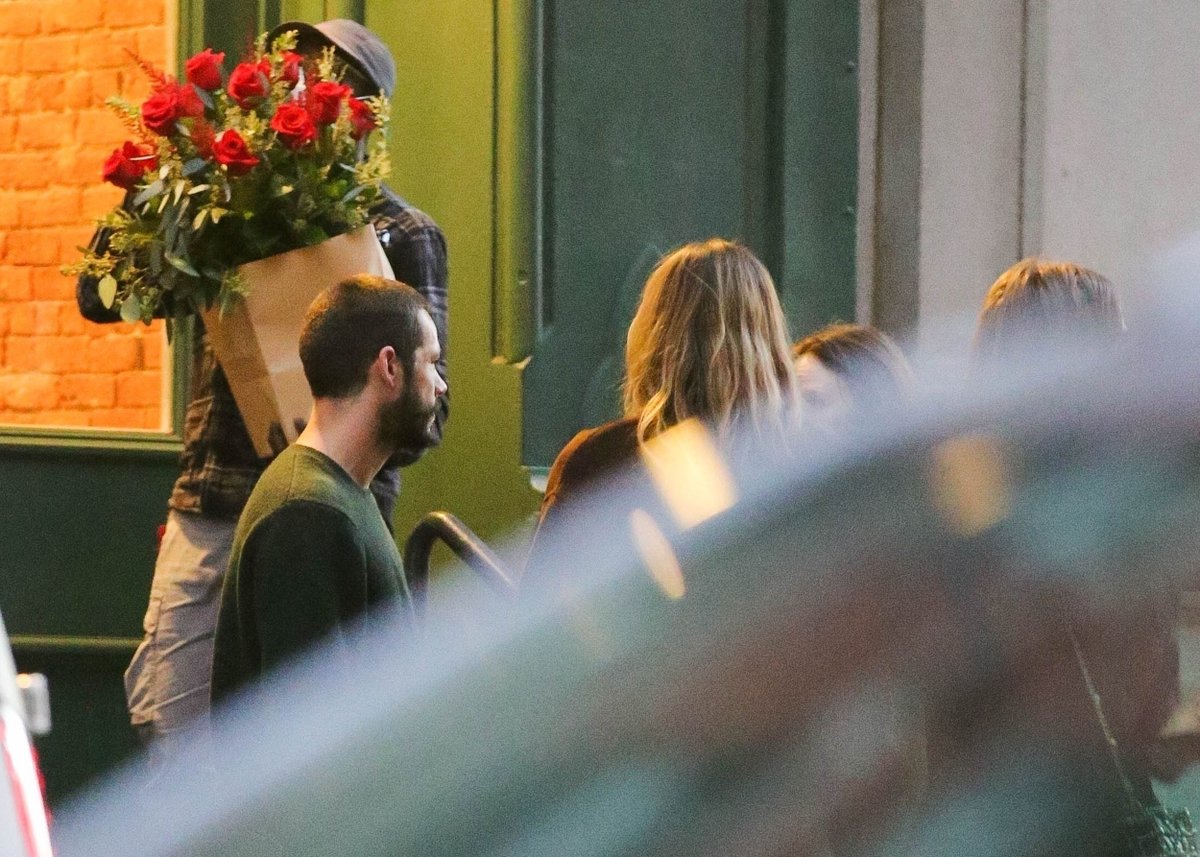 Dylan O'Brien seen arriving at Taylor Swift's apartment in NYC with red roses.