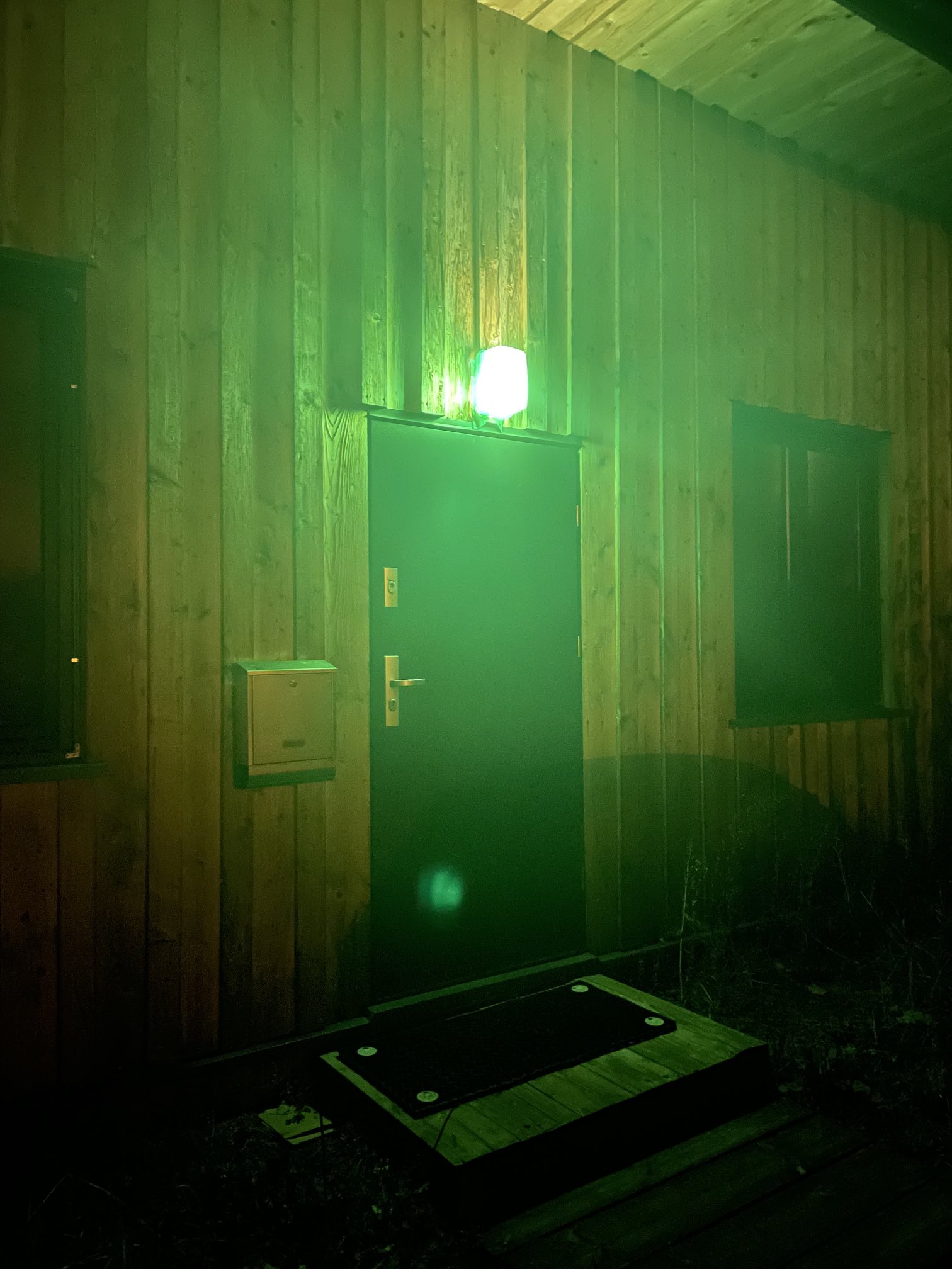 Green light outside house outlet