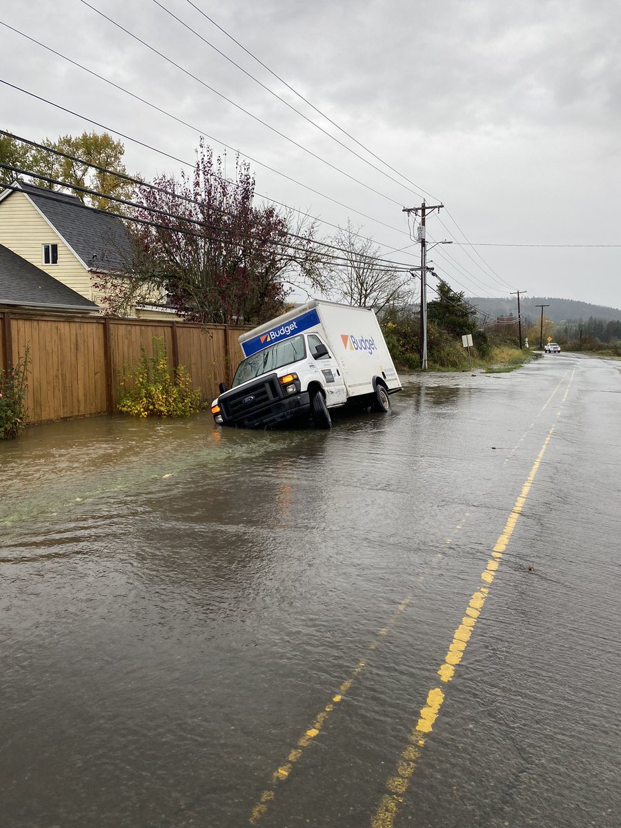 Delivery truck attempting to turn around on flooded road couldn’t see ditch and got stuck. This is on Gaston Road across from Brown Park. They’re waiting for a tow out.