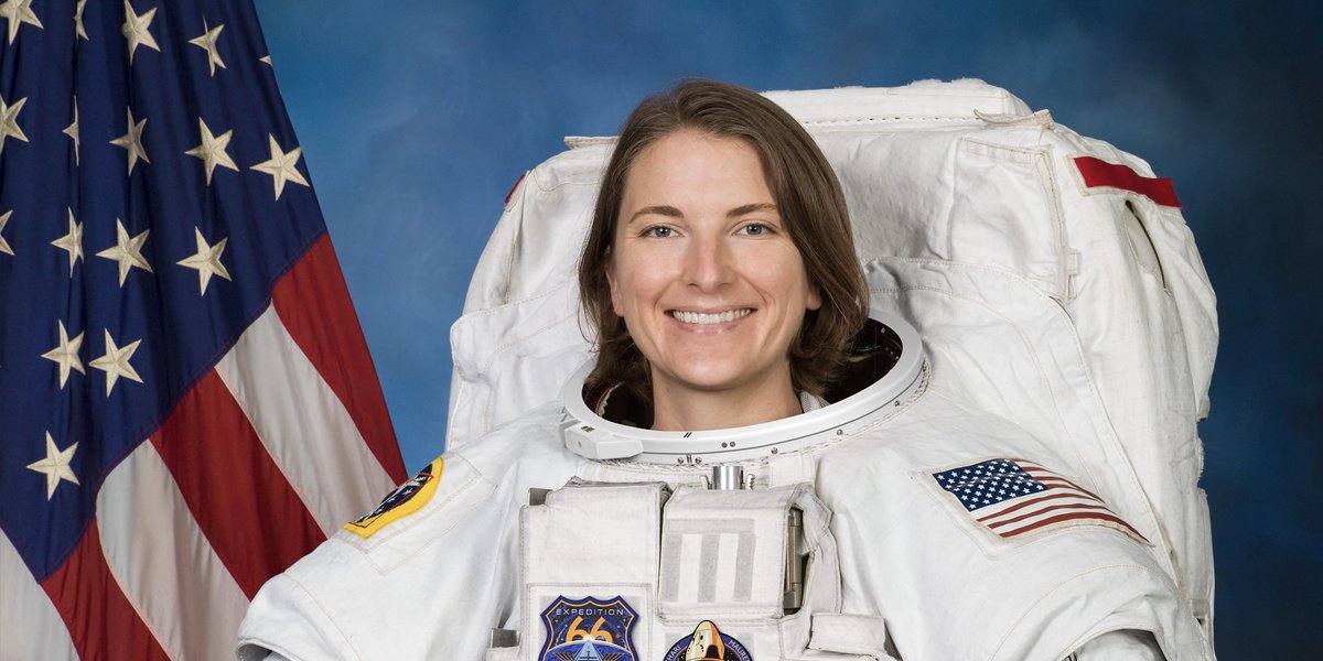 Official NASA astronaut portrait of Kayla Barron in spacesuit holding helmet