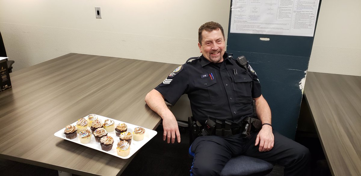 ChiefHyland's tweet photo. A packed briefing and not a dry eye in the house as @NewWestPD Sgt Mike Garbutt works his last patrol shift before retiring after 32+ years serving the City of #NewWest. One of the most caring members I have ever had the privilege of working with...Mike you will be missed by all! https://t.co/bFDHjaCijv