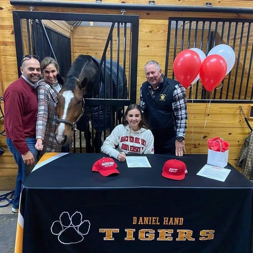 ciacsports's tweet photo. It's been AWESOME to see schools across the state post photos of their student athletes signing NLIs to compete in college. Coolest one we've seen? Might be @HandTigers Beverly Banerji signing for equestrian with @SHUBigRed - Horse named "Gio" (Adagio)! https://t.co/ro5AX604e2