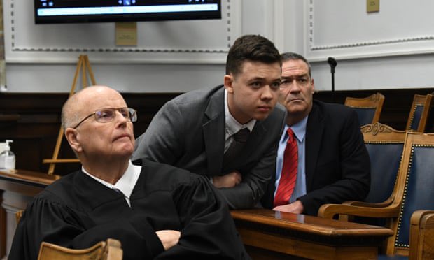 JackPosobiec's tweet photo. No one in the room felt the need to say or do anything about an ‘accused double murderer’ leaning over the judge from behind, completely unshackled

Tells you everything you need to know https://t.co/PhgtwaYQEa