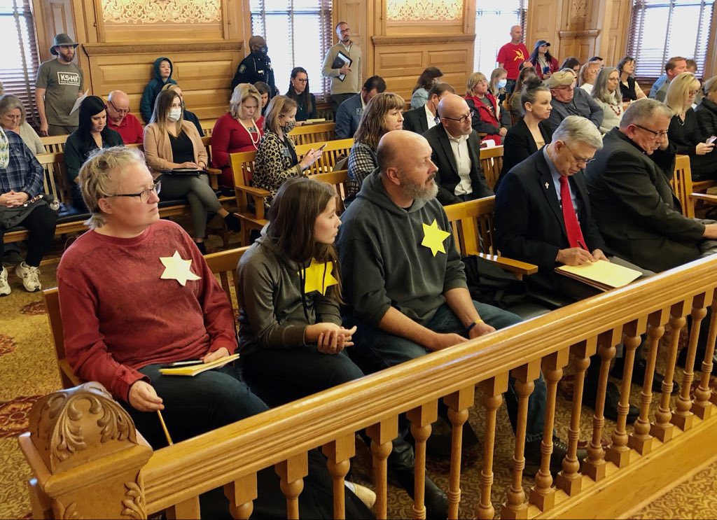 mattxiv's tweet image. anti vaxxers in kansas showing up to town meetings wearing the gold stars that jews were forced to wear during the holocaust.. there is a special place in hell