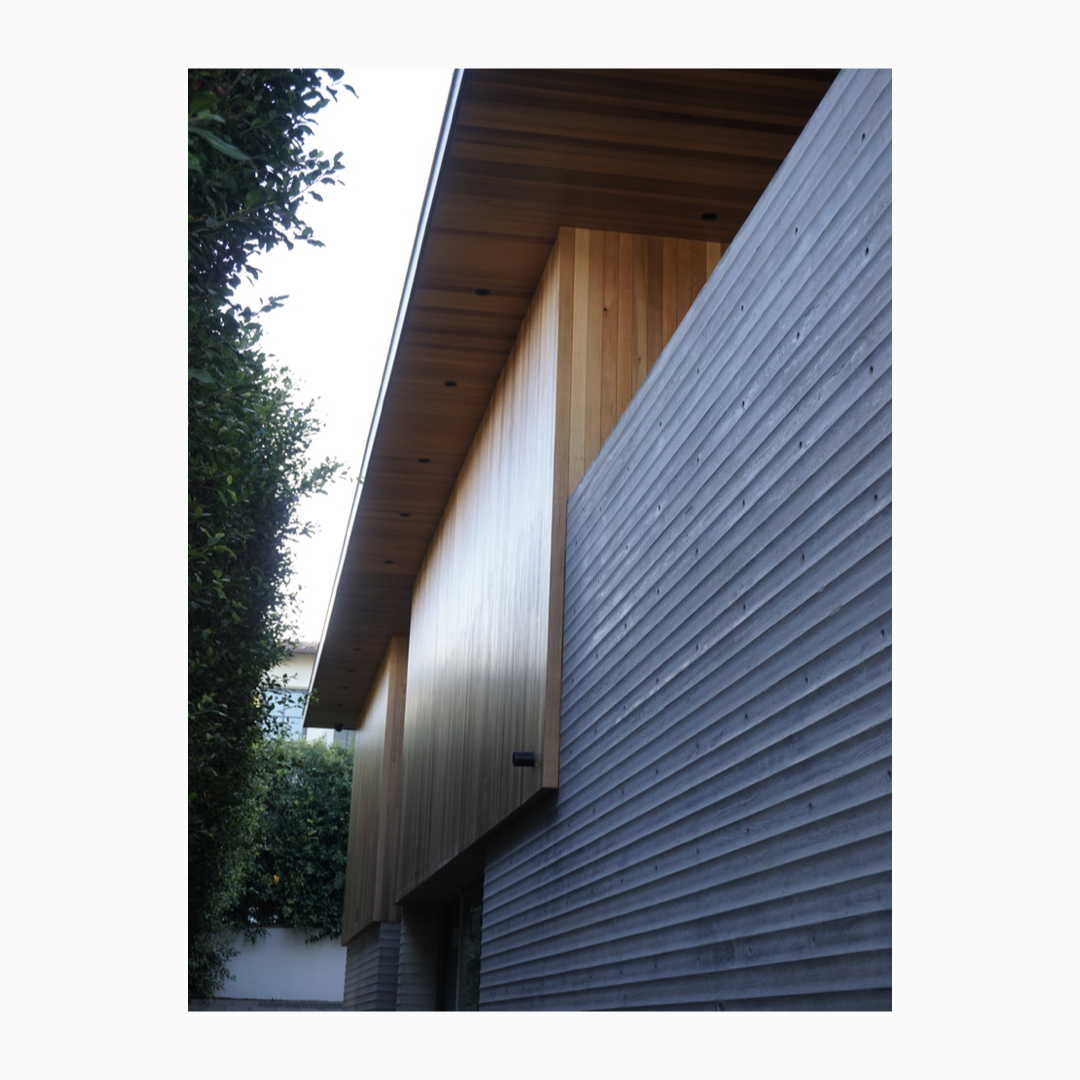 Many home rely upon glass to define the facade, which can lead the exterior to appear flat, shiny, &amp; institutional.  In contrast, this residence uses deep subtractive voids, inviting light to flood the home, allowing the facade to be defined by scalloped concrete and cedar.