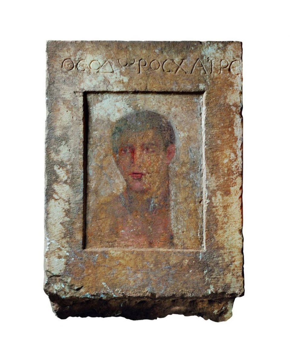 ArchaicWorlds's tweet photo. An ancient Greek encaustic painting on marble depicting the portrait of a young man from a grave stele, with a tombstone inscription declaring "ΘΕΟΔΩΡΟΣ ΧΑΙΡΕ" or "Farewell to Theodoros" on one side. The painting is dated to the 1st century BC. https://t.co/9R6CLI9nBx