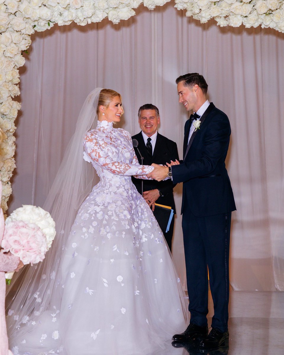 ParisHilton's tweet photo. Standing hand in hand at the altar, my heart skipped a beat. It was one of the most incredibly magic and loving feelings I’ve ever felt in my life. I am so proud to be your wife and excited for the future we will create together. 👰🏼‍♀️💍🤵🏻♾❤️ #ForeverHiltonReum 📸: @GermanLarkin https://t.co/iXag2mq3CW