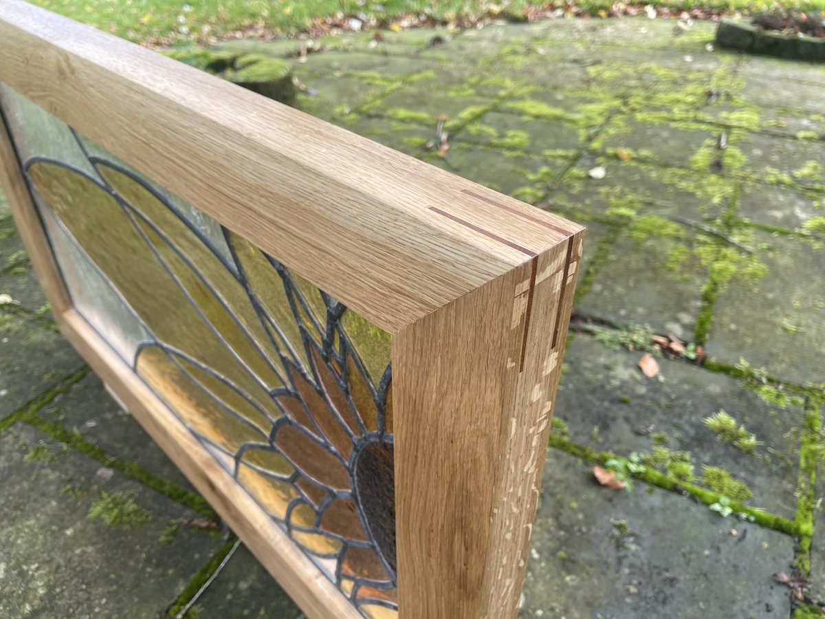 Ir8Bespoke's tweet photo. Recently a customer came to me with a stained glass panel a friend had made for their previous house but had been sat in storage since the move. 

I framed it in a solid oak frame with mitred joints wedged with slips of sapele to help the accent, then hand oiled with serval coats https://t.co/e5Gs1raorr