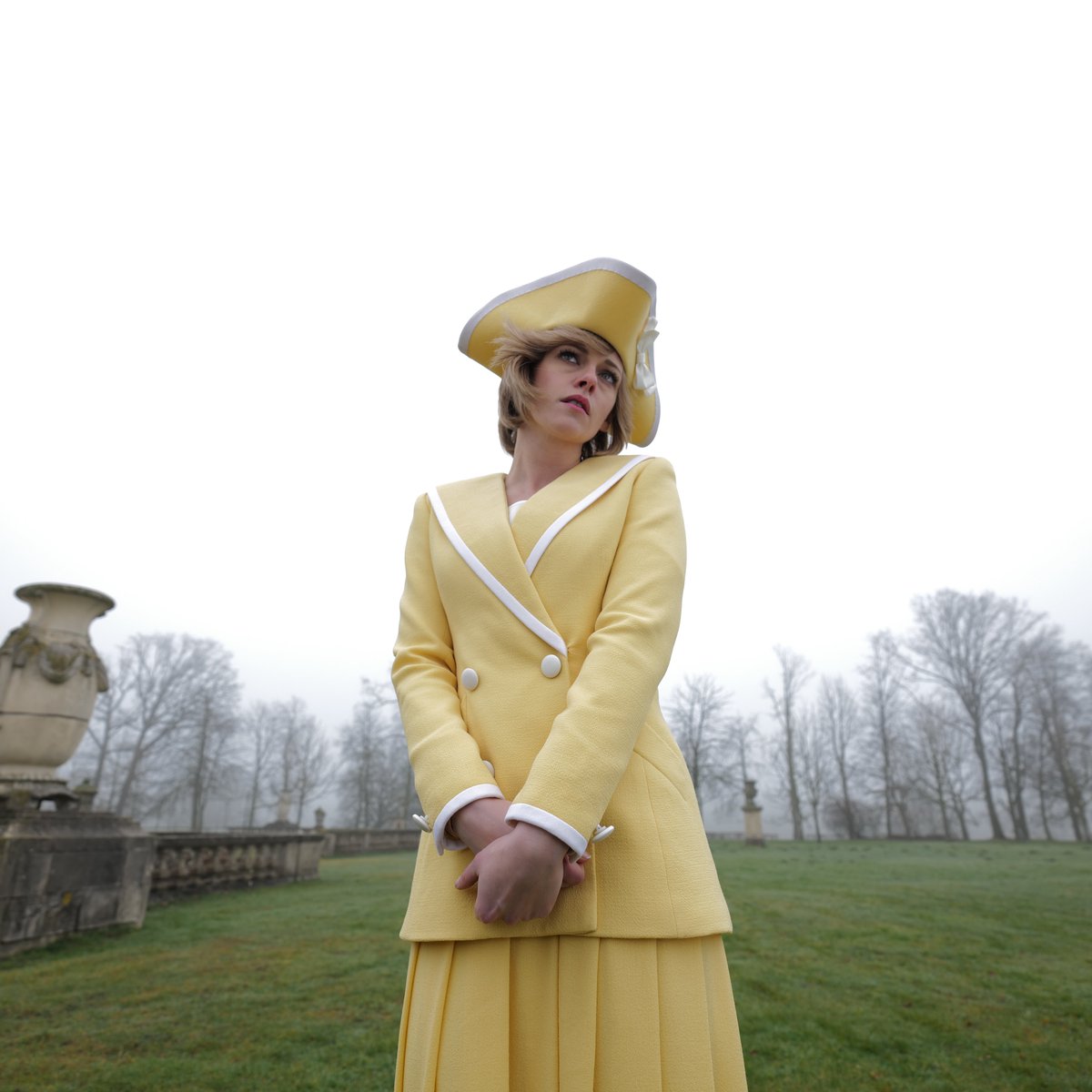 Kristen Stewart as Diana in Spencer, wearing two piece lemon suit skirt. 