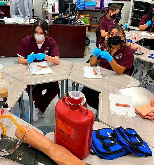 CRYROP's tweet photo. #CRYROP Clinical Medical Assistant students in Ms. Uraine's class @YucaipaHigh working on their injections! Great start to their hands on skills practice! @YCJUSTWEETS @ColtonJUSD @RedlandsUSD @SBCCDcolleges @RCCDistrict @CityofYucaipa @ArrowheadRMC @LLUHealth #CareerTechEd https://t.co/5NVY0k0d11
