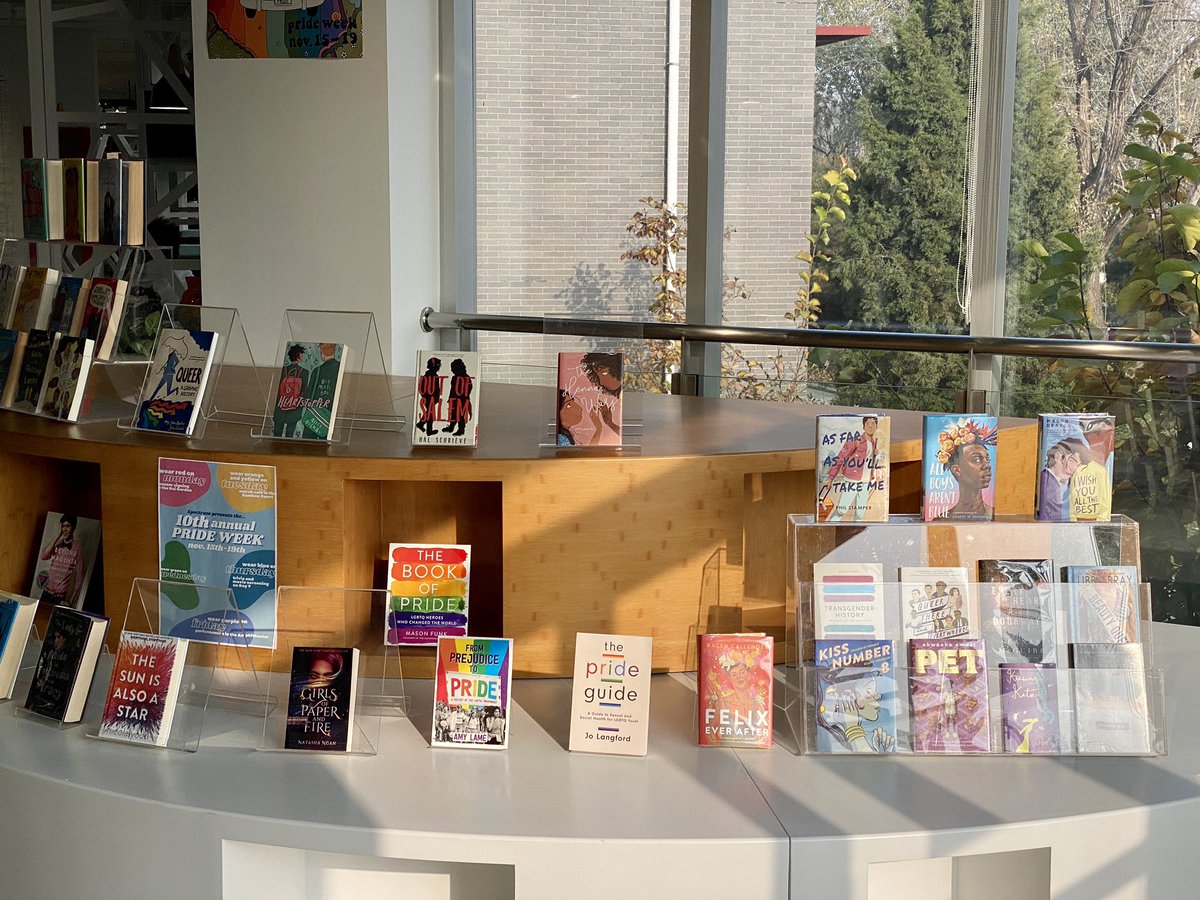 klbeasley's tweet photo. 🏳️⚧️🏳️🌈 Our awesome library staff are supporting Spectrum’s 10th Annual Pride Week by featuring books with queer themes for their Library display in the HS at @WAB_LIVE #allyed @tricia_fried Have you read these titles? #tlchat #intlchat https://t.co/uFBbBNjE4M