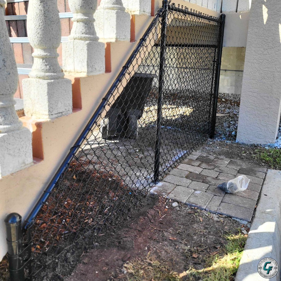 CarterFence's tweet photo. Black vinyl coated chain link fence install complete down in Marco Island. This diagonal cut to follow the stairs is called a California cut - great work by Jorge and crew! 
https://t.co/23DrOQmnit
239-353-4102 https://t.co/QzwwtGPNb0