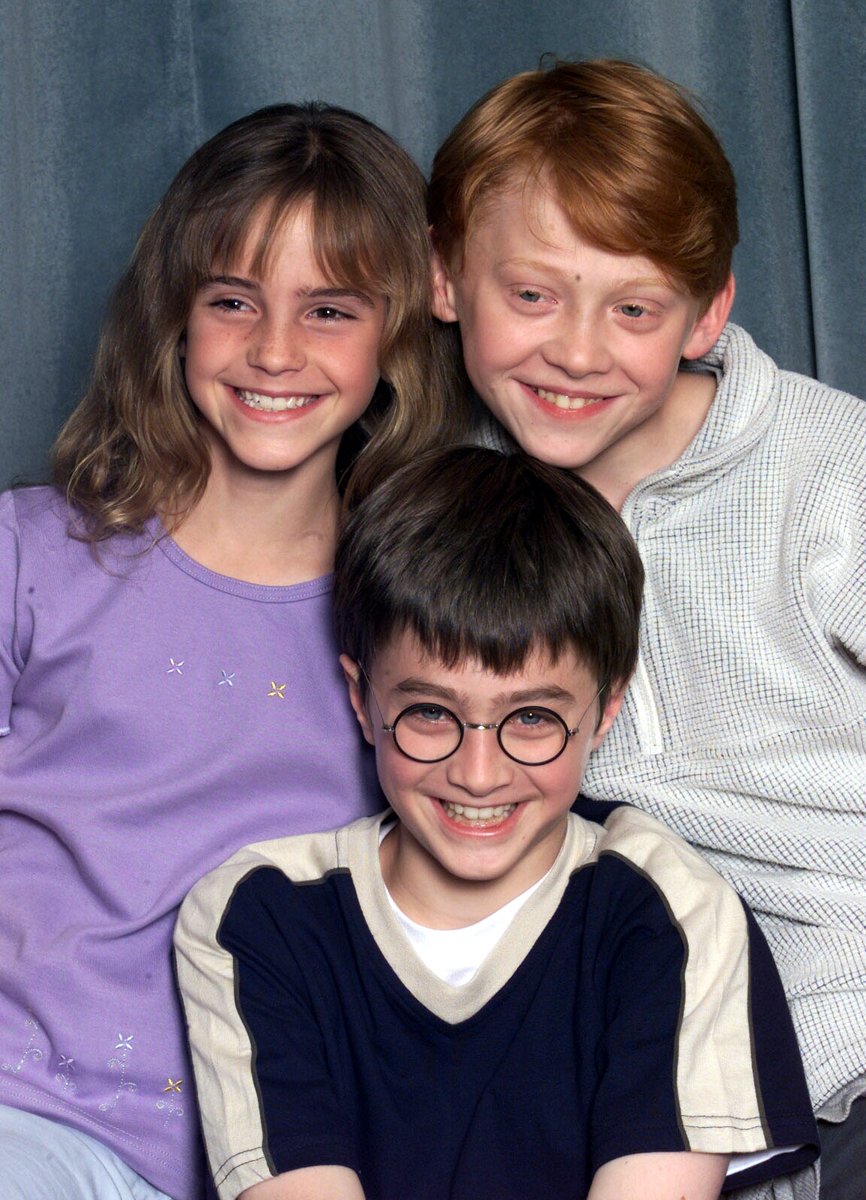 MTV's tweet photo. While we wait to celebrate two decades of #HarryPotter with a #ReturnToHogwarts on @hbomax... I present to you this outrageously adorable photo of Emma Watson, Rupert Grint, &amp; Daniel Radcliffe. https://t.co/Zs35yDx5MA