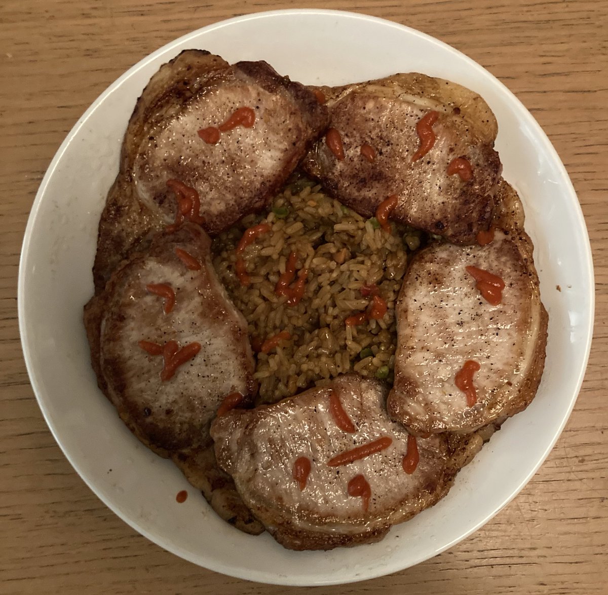 5 caramelised loins from a porka on a bed of savoury rice from fields  tended by paddy’s and a splash or two of red hot chilli jus #Mmmmm